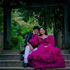 A dramatic and romantic portrait of an expecting couple. I use architectural elements and natural surroundings in Bangalore's parks to frame your story, creating timeless images that feel both grand and intimate.