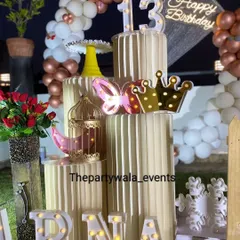 A close-up of the rooftop party decor, showing the beautiful props like the light-up butterfly, crown, and birdcage. These details add a magical touch.