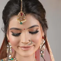 A moment of quiet joy. This shot captures the soft, blended eyeshadow, delicate lashes, and perfectly defined features that create a timeless bridal look.