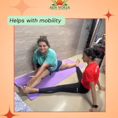 With the right support, you can safely push your limits. In this home session, I am assisting a client with a deep stretch to improve her mobility and leg flexibility, a common goal for many who start their yoga journey.