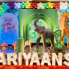 Personalization is key. Here, I've added large, light-up marquee letters with the birthday boy's name, Hariyaansh, right in front of the main jungle stage for a personalized touch.