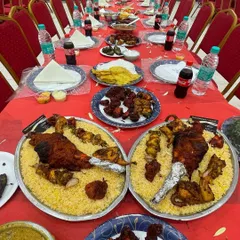 This is what a true dawat looks like. Here is a table I catered for a function, laid out with large platters of chicken mandi, various kebabs, and an assortment of starters for guests to enjoy.