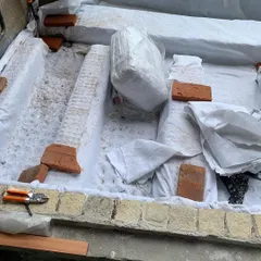 Preparing the foundation for a large planter bed. We use a waterproofing layer and drainage cells to ensure the structure is sound and the plants stay healthy.