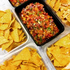 A classic party snack, our homemade Nacho chips are served with a generous portion of fresh, spicy tomato salsa. We also offer a unique pineapple salsa for a sweet and tangy twist.