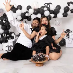 Celebrations should be full of life and personality. This family is having a blast during a Chanel themed cake smash session, complete with a custom balloon arch and designer props provided by our studio.