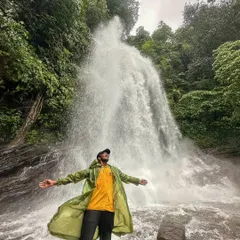 A trekker embracing the full force of Hidlumane Falls. It's an experience that washes away all your city stress.