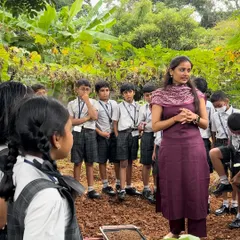 Our trainer leads a session with students in the open field, explaining the basics of soil health and planting. These outdoor classrooms provide an unforgettable, practical learning experience.