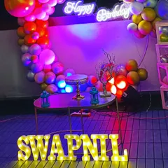 A stylish surprise birthday party for a husband. This setup features a modern ring balloon decoration with neon lighting, creating a cool and celebratory vibe perfect for an adult's party.