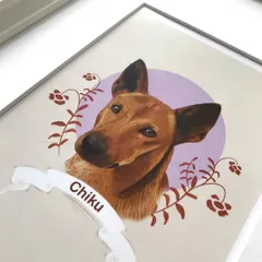 A close-up of the framed portrait of Chiku. This angle shows the clean edges of the frame and how the artwork sits securely behind the glass, protected and ready for display.