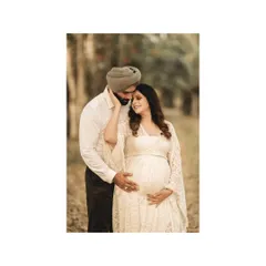 The expecting mother's serene smile says everything. This tender moment, with his hand on her cheek, is a beautiful testament to their shared love and excitement.