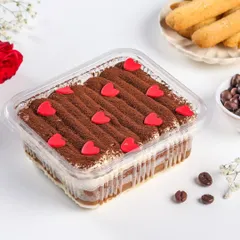 Our eggless Tiramisu tub, decorated with little hearts for Valentine's Day. It's a classic dessert, perfect for sharing with your special someone.