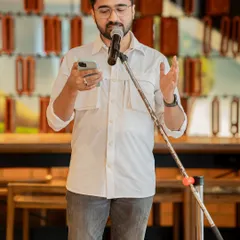 A performer reads from his phone, contributing his voice to our "Love Without Labels" session. Every poem added to the celebration of unfiltered and unapologetic love.