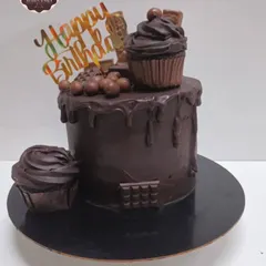 A rich, dark chocolate overloaded cake. This cake is frosted with chocolate truffle and decorated with more chocolate, including a mini cupcake on top.