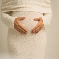 A heart for your baby. This simple, beautiful gesture of hands forming a heart on the bump is a classic for a reason. It's a pure and direct expression of love.