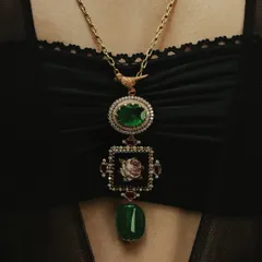 My classic rose pendant, handcrafted with a micromosaic center, Zambian emeralds, and rubies. The design is meant to be a timeless piece that can be passed down through generations.