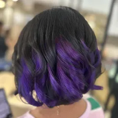 For those who want a playful pop of color, I created this peek-a-boo purple look. It's a fun way to experiment with vivid hair color, adding a flash of personality to a classic bob haircut.