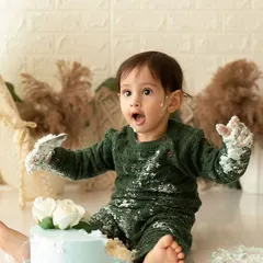 The moment of surprise and excitement is what makes a cake smash so special. This shot captures that perfectly in our boho-themed studio setup.