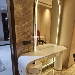 A perfect example of functional luxury. We crafted this elegant vanity table for a client's personal dressing space, featuring a sleek curved design, integrated drawers, and a beautiful arched mirror with built-in ambient lighting.