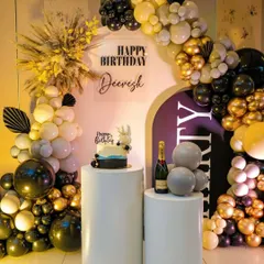 This is a perfect example of a sophisticated birthday setup for an adult. I used a classic black, gold, and white color scheme with a modern arched backdrop, a custom acrylic sign, and elegant white pedestals for the cake and champagne. The dried pampas grass adds a trendy, textural element.