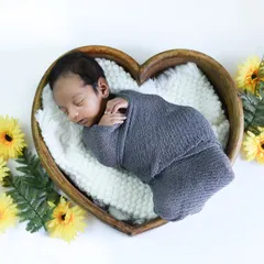 So tiny and perfect. In our newborn sessions, we create a safe and cozy space, using soft props like this heart-shaped bowl to photograph your baby's earliest, most peaceful moments.