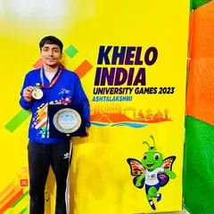 The result of dedication. Our boxer, Krishan Thakran, proudly displays his Gold Medal and plaque after winning the Khelo India University Games 2023.