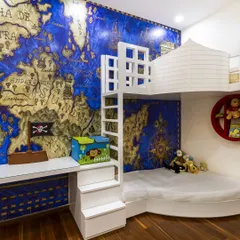 A room to spark imagination! This pirate-themed kids' room features a custom bunk bed with stair storage and a stunning world map mural. It's a space for adventure and dreams.