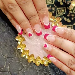 A playful and romantic design with bright pink French tips, white line details, and cute heart accents on square nails.