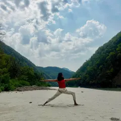 Opening up in Virabhadrasana II, the warrior two pose, with the majestic Himalayas as my backdrop. This pose builds strength and stability, reflecting the mountains around us.