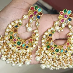 These Navratan style chandbali earrings are full of life and color. The combination of multiple semi-precious stones and pearl drops makes them a versatile choice that can be paired with many different festive outfits.