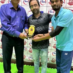 Recognizing a winner from our corporate badminton tournament with a plaque. These events are perfect for professionals who want to compete outside of work.