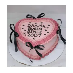 A fun "Drama Queen" cake with vintage piping. This heart-shaped choco-blueberry cake combines pink frosting with black ribbons for a bold and stylish look.