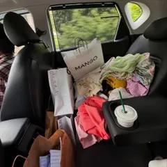The not-so-glamorous but very real side of a stylist's life. My car often doubles as a mobile wardrobe, packed with shopping bags, clothing options, and of course, coffee to fuel a busy shoot day.