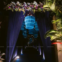 We believe the event experience begins at the entrance. This immersive walkway, featuring a tunnel of glowing blue chandeliers and dramatic drapery, creates a grand and memorable first impression for guests attending an exclusive corporate function or evening gala.