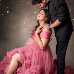 A romantic portrait celebrating your love story. Here, I used soft lighting and a sprinkle of magic to enhance the tender moment between the couple, with the mom-to-be seated in a beautiful pink tulle gown.