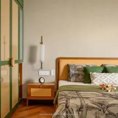The master bedroom in 'Cover me in Sunshine' is an earthy retreat. The wardrobe, finished in a lush green with rattan panels and custom circular wooden handles, harmonizes with the room's natural and serene character.