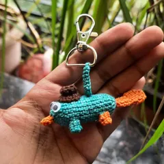 It's Perry the Platypus! This keychain features the iconic character from Phineas and Ferb, complete with his secret agent fedora. A perfect piece of cartoon merch for fans.