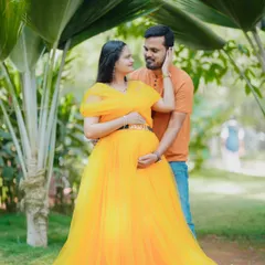 A tender moment captured in a sun-drenched garden. This photo showcases a beautiful yellow gown and the loving connection between the couple in a natural, romantic setting.