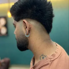 The back view of this edgy mullet shows the distinct separation between the faded sides and the textured length at the nape. This style is all about strong lines and attitude.