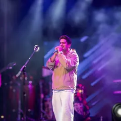 A key part of concert photography is capturing the artist's presence. Here is singer Amit Prakash Mishra performing under the dynamic stage lights at FLAME University.