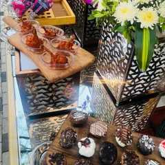 A tempting display of sweet and savory treats. This photo shows a platter of assorted mini donuts alongside spicy chicken lollipops, offering something for every craving.