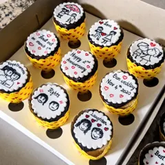 Another set of hand-painted cupcakes celebrating a couple's anniversary, with each cupcake marking a milestone in their relationship.
