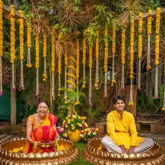 For this unique Haldi setup, the couple sat in large traditional brass 'urulis' filled with flowers, creating a fun and photogenic moment.