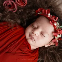 A sleepy smile is the most precious thing. I love capturing these fleeting expressions on a safely swaddled baby, nestled in soft fur with a delicate floral crown.