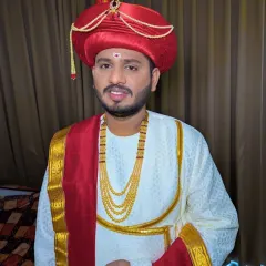 A happy Maharashtrian groom, ready for his wedding. The makeup is subtle, enhancing his features to match the grandeur of the Peshwai outfit.