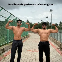 Real friends push each other to grow. A photo with a friend, both flexing.