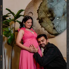 An intimate moment between expecting parents is priceless. We focus on capturing that deep connection, like this quiet moment of Anurag listening to his baby's heartbeat, creating a memory filled with love and anticipation.