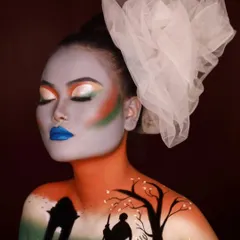 A side profile of the creative Independence Day makeup, showing the seamless blend of colors across the face and chest. Our courses teach students how to use the human body as a canvas.