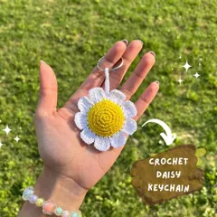 A close-up of our handmade crochet daisy keychain, a perfect little floral surprise to gift to your loved ones.