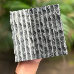 For another 'Texture Thursday,' we're showcasing this hand-chiseled stone. The raw, irregular grooves create a beautiful tactile surface that plays with light and shadow.