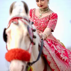 For a grand entrance, your hairstyle needs to be as stunning as your outfit. Here, I created a look with a secure updo and elegant details that stayed perfect, even for a dramatic outdoor photoshoot. This showcases my work on a modern lehenga look.